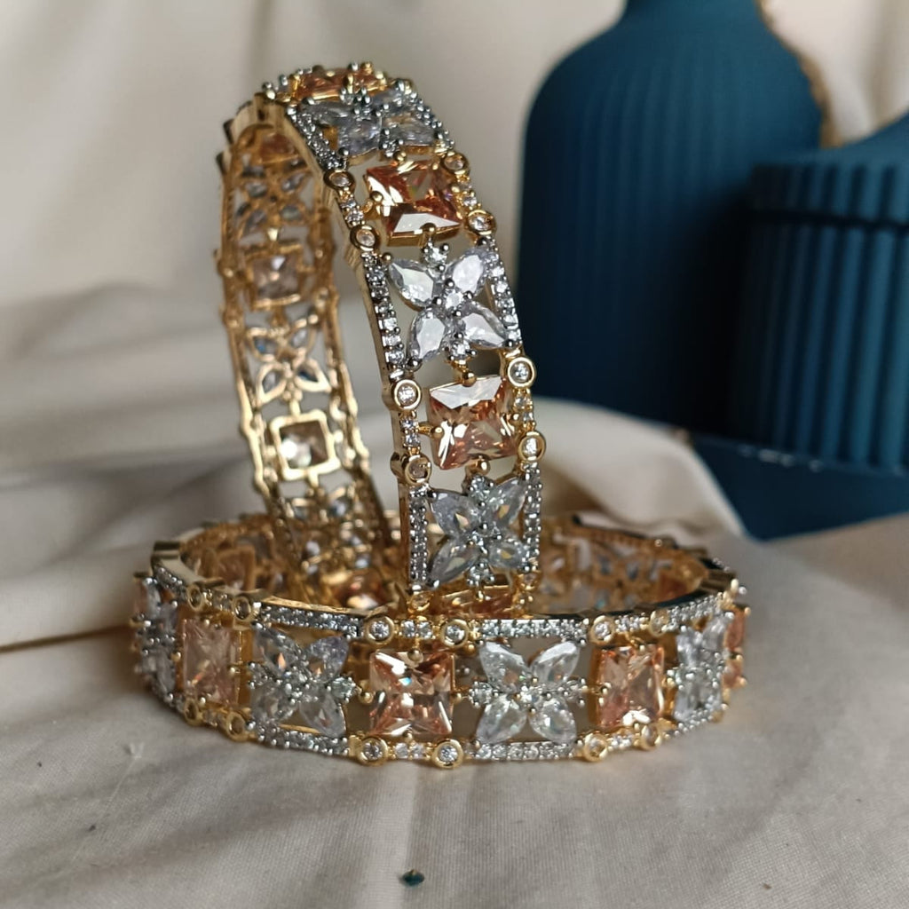 Gold and diamond bracelet on a textured surface with a blurred background