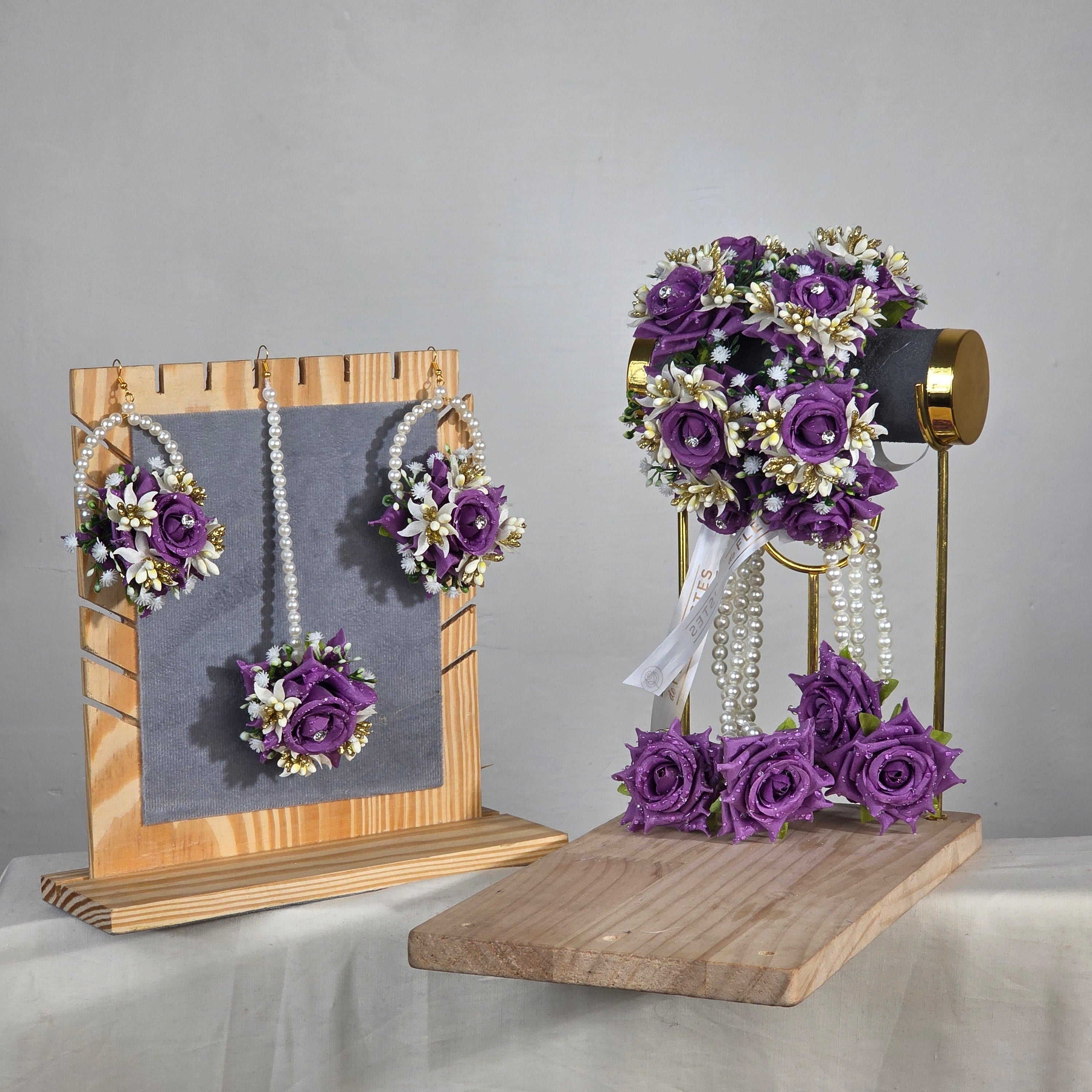 Set of purple flower k artificial kaleera gajra pair worn by a mehndi bride.