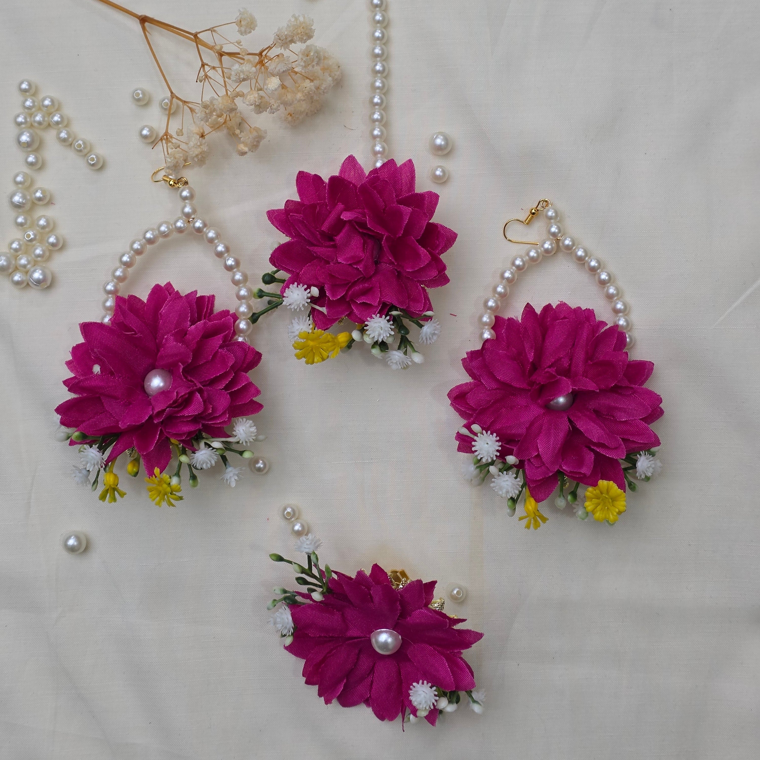 A bride wearing the Hot Pink Bliss floral jewelry set for a festive Mehndi celebration in Pakistan.