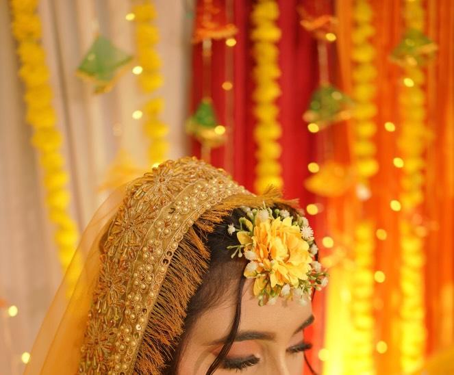 Decorative headpiece with flowers against a colorful background